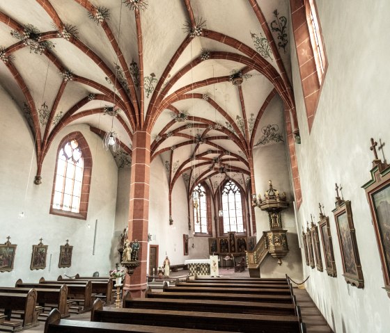 Interior view of St. Nicholas Church with impressive Gothic vaulting, pews and decorative murals., © Eifel Tourismus GmbH, Dominik Ketz Interior view of St. Nicholas Church with impressive Gothic vaulting, pews and decorative murals., © Eifel Tourismus GmbH, Dominik Ketz