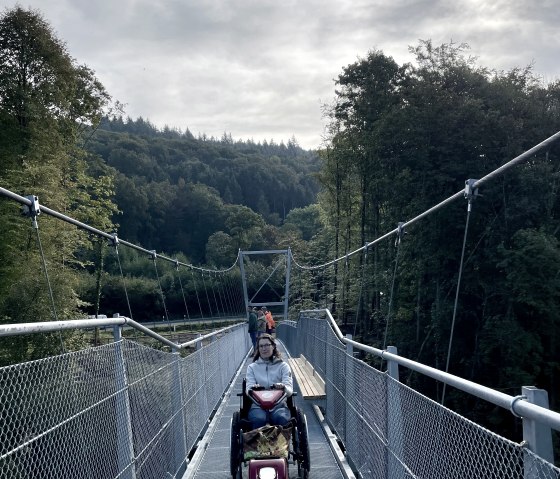 Travel barrier-free on the suspension bridge over the Irrel waterfalls with the Swiss Trac., © Naturpark Südeifel, Ansgar Dondelinger